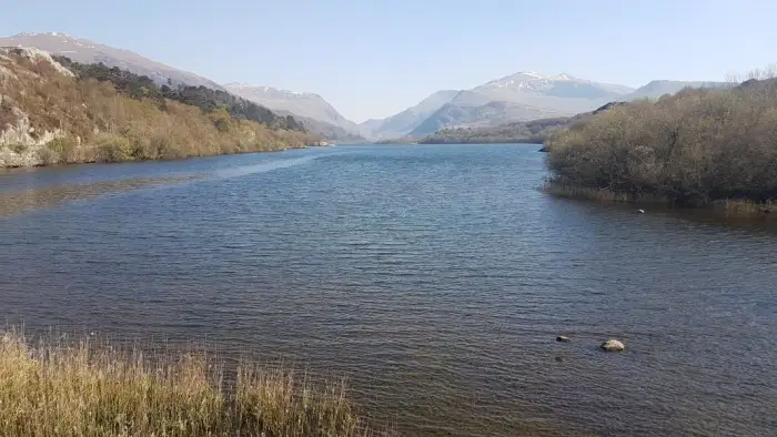 Padarn Lake with snow on Mount Snowdon