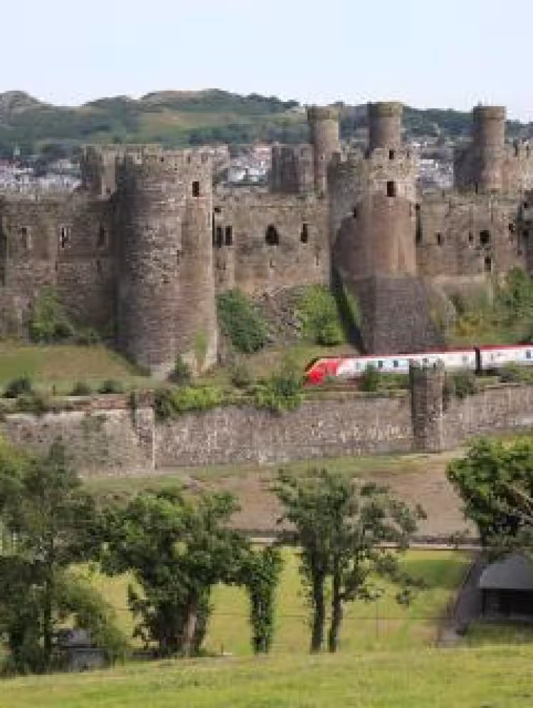 Virgin Train passing Conwy Castle on route to London